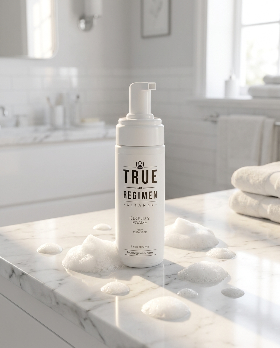 True Regimen Cloud 9 Foamy Cleanser beside a white towel in a bright, airy bathroom setting